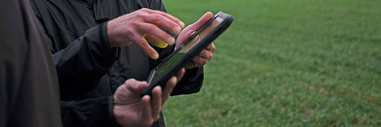 Hands holding a tablet device